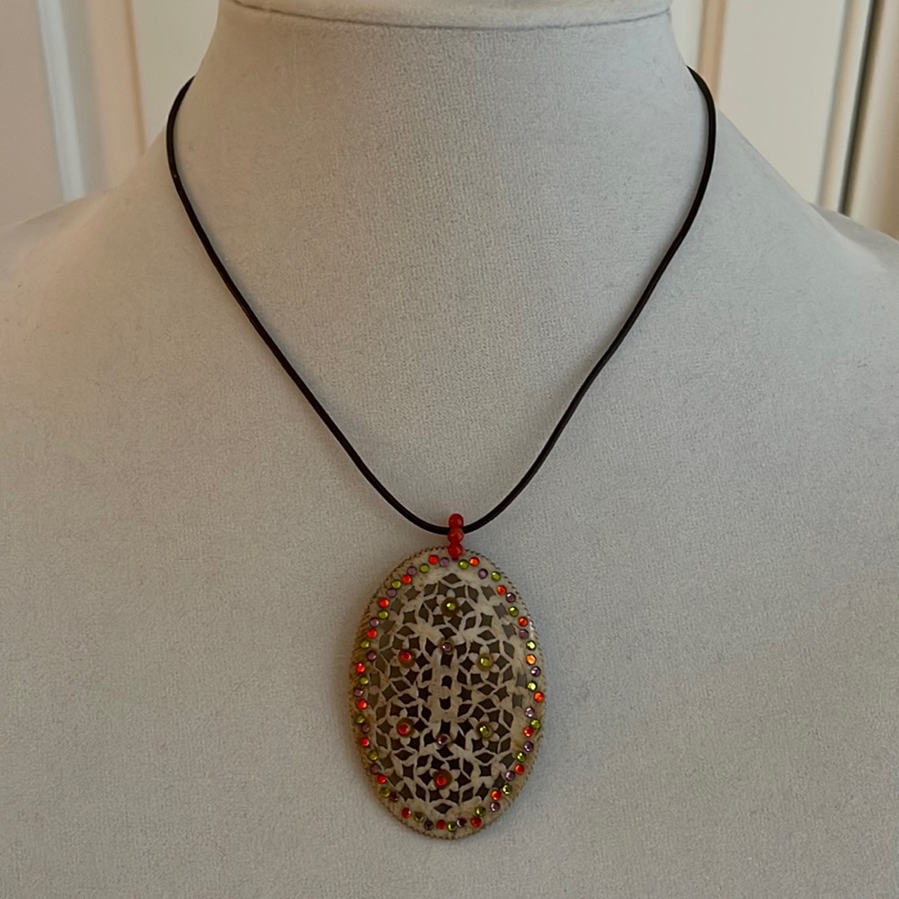 Pretty pendant on chord.